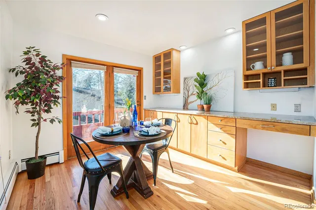 a dining room with furniture and large windows