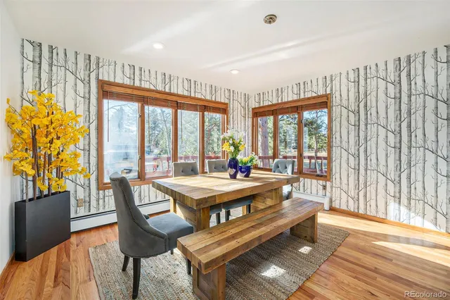 a dining room with furniture a chandelier and wooden floor