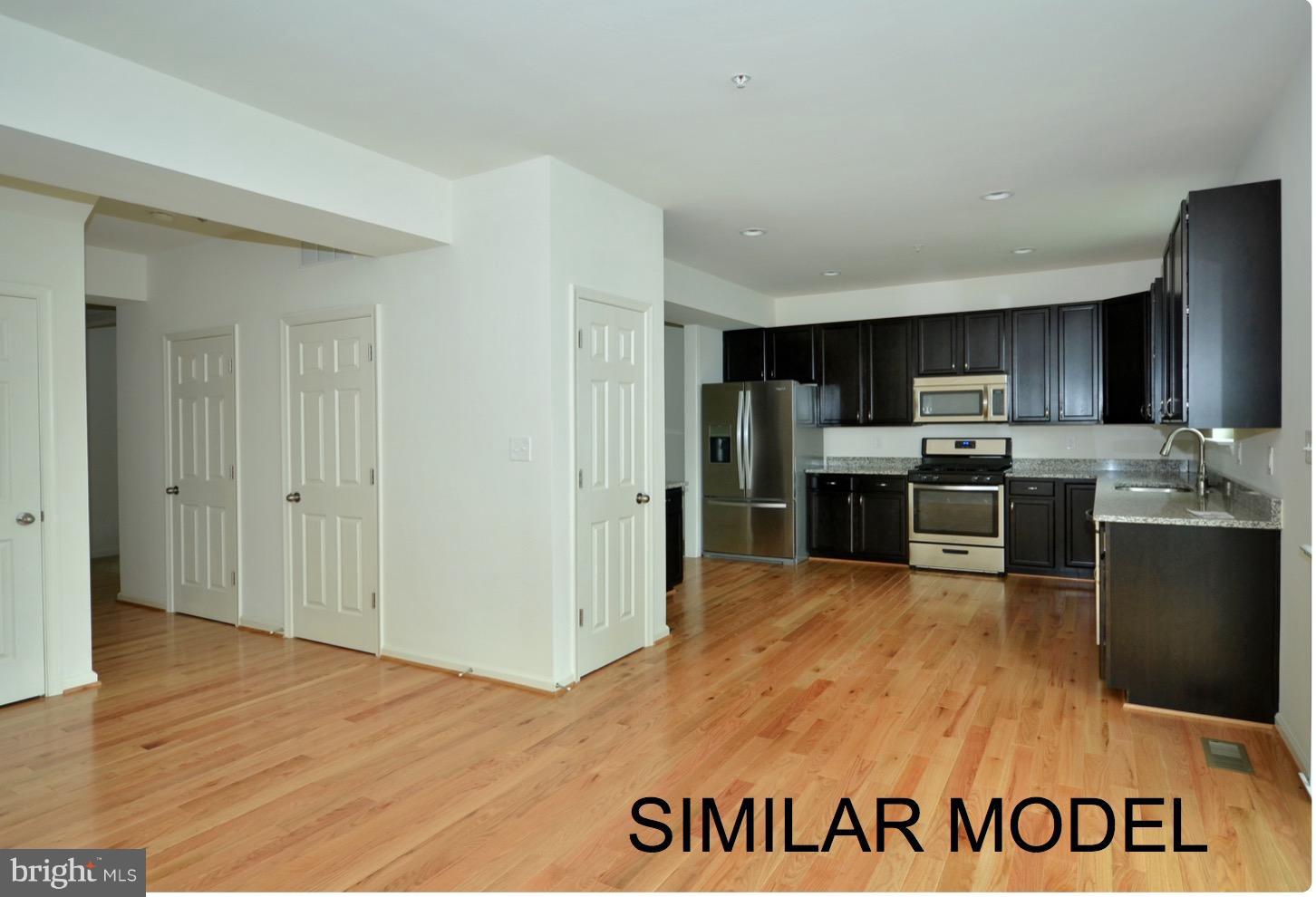 8006 Hillendale Road Parkville, MD 21234 - Photo 11 of 16 a kitchen with granite countertop a refrigerator and a sink