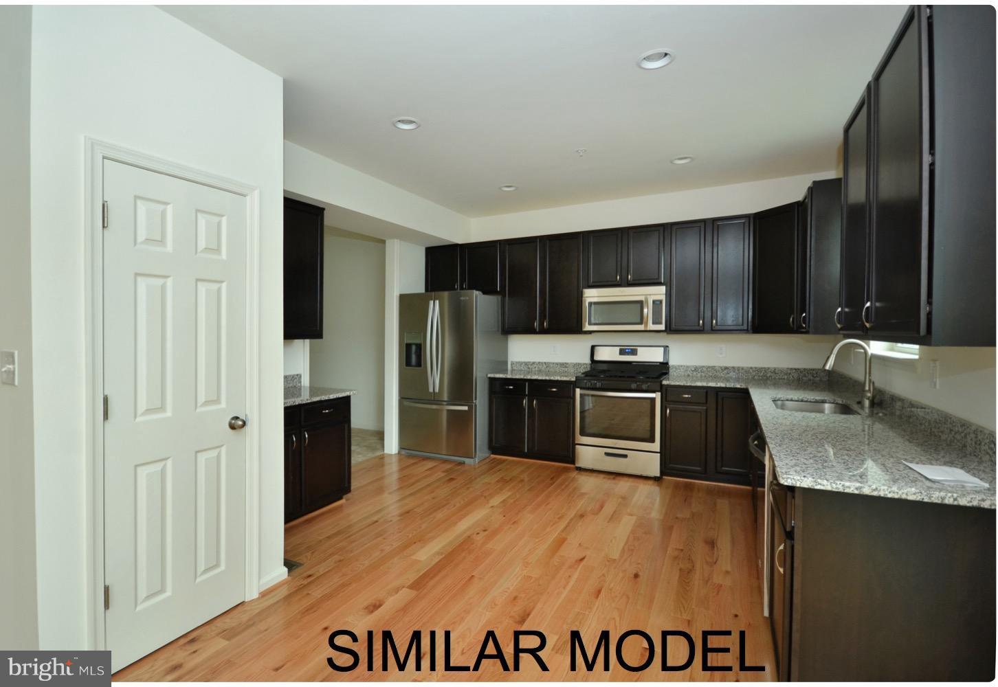8006 Hillendale Road Parkville, MD 21234 - Photo 12 of 16 a kitchen with granite countertop a refrigerator and a sink
