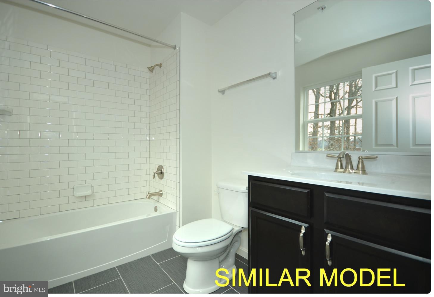 8006 Hillendale Road Parkville, MD 21234 - Photo 13 of 16 a bathroom with a sink a toilet and shower