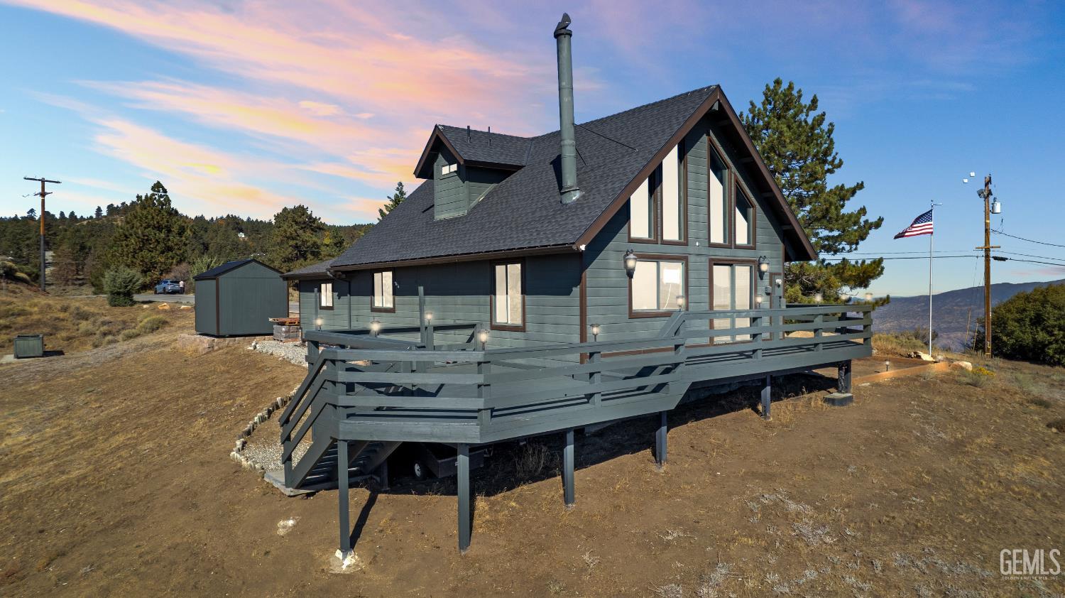a view of a house with backyard and sitting area
