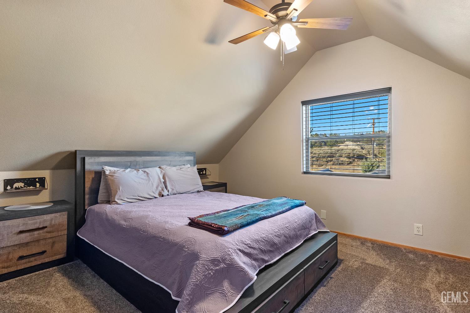 Undisclosed Address Tehachapi, CA 93561 - Photo 14 of 42 a bedroom with a large bed and a chandelier