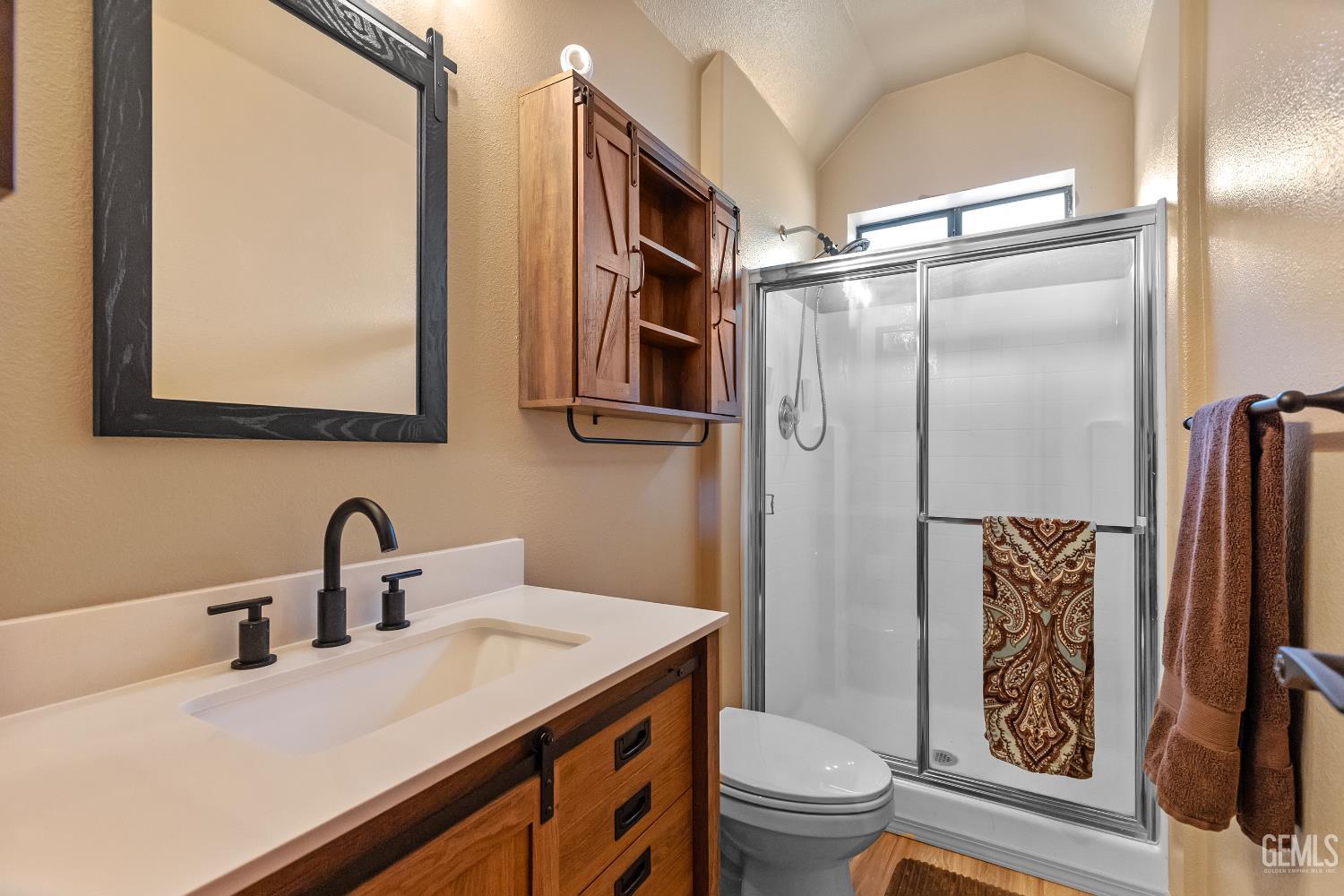 Undisclosed Address Tehachapi, CA 93561 - Photo 15 of 42 a bathroom with a sink a toilet a mirror and shower