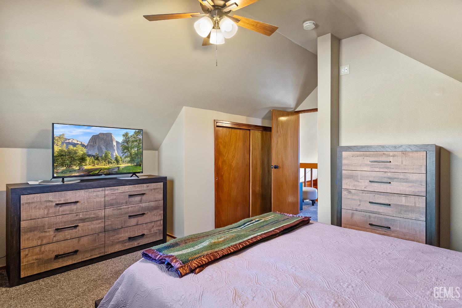 Undisclosed Address Tehachapi, CA 93561 - Photo 17 of 42 a bedroom with a bed and a mirror on the dresser