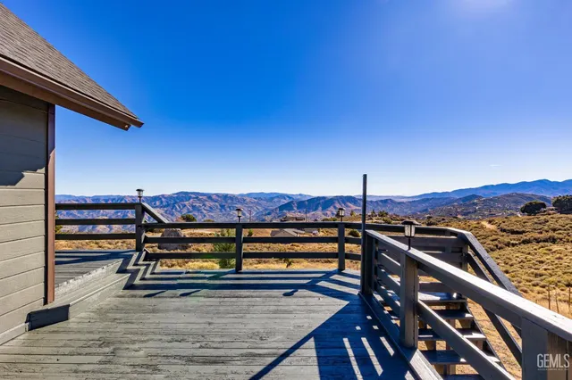 a view of a house with wooden fence