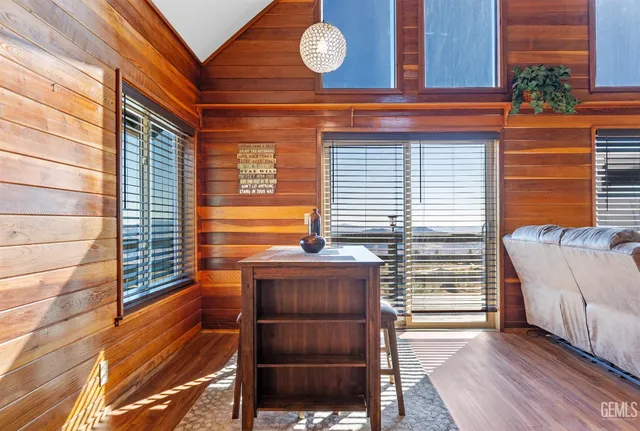 a kitchen with kitchen island granite countertop a sink cabinets and wooden floor