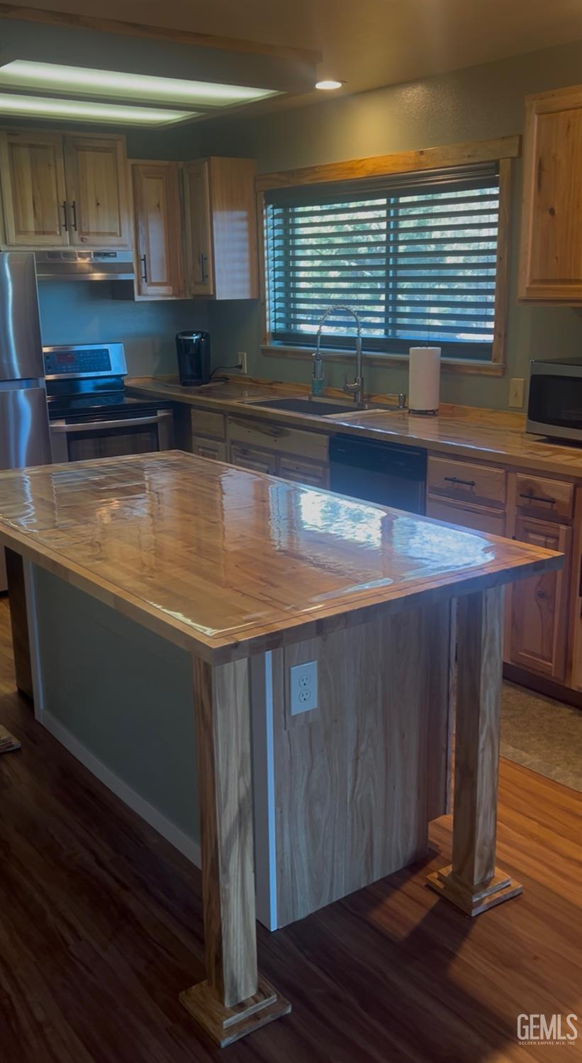 Undisclosed Address Tehachapi, CA 93561 - Photo 7 of 42 a kitchen with kitchen island granite countertop a sink cabinets and wooden floor