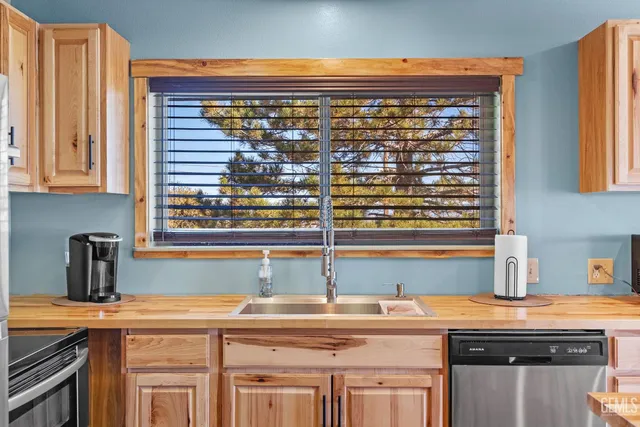 a bathroom with a sink a toilet a mirror and shower