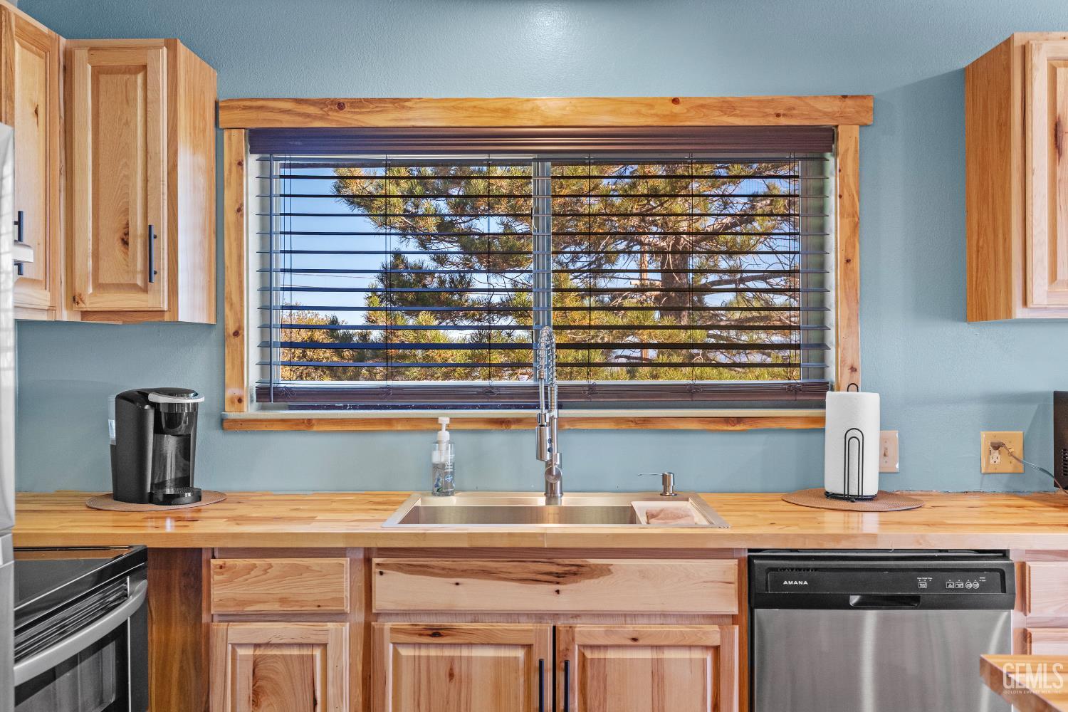 Undisclosed Address Tehachapi, CA 93561 - Photo 9 of 42 a kitchen with stainless steel appliances granite countertop a sink and a wooden cabinets