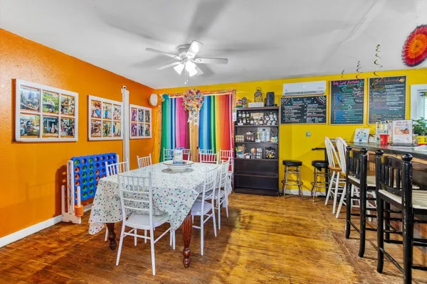 a dining room with furniture window and wooden floor