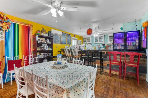 a view of a dining room with furniture and chandelier