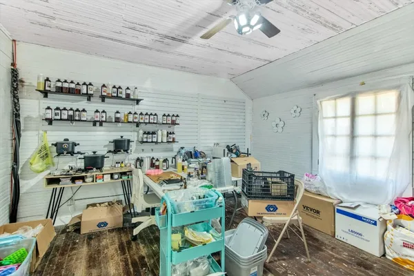 a room with furniture a chandelier fan and a window