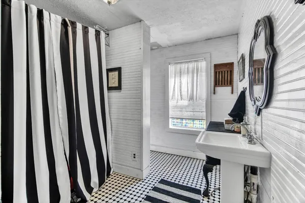 a spacious bathroom with a bathtub and shower