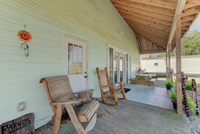 a view of a house with garden and a yard