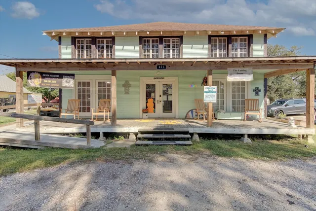 a front view of a house with a garden and swimming pool