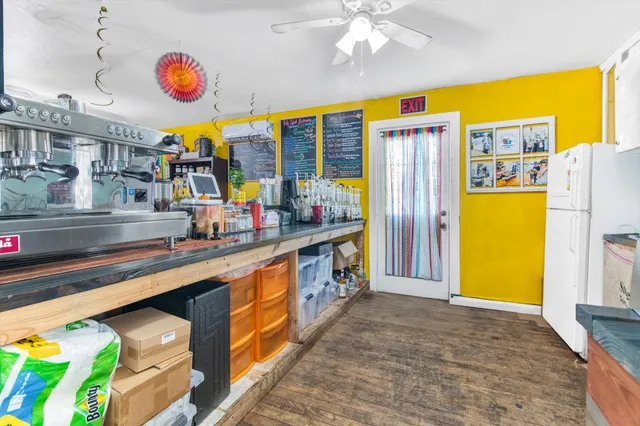 a kitchen with stainless steel appliances granite countertop a sink and a refrigerator