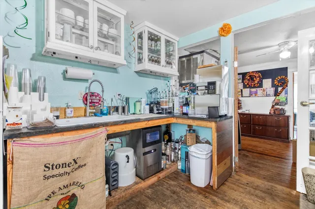 a utility room with stainless steel appliances a stove and cabinets