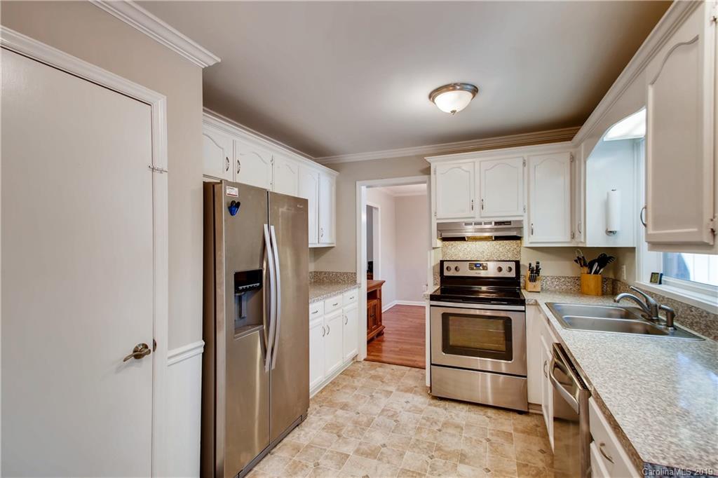 503 Southland Road Huntersville, NC 28078 - Photo 3 of 26 a kitchen with stainless steel appliances granite countertop a refrigerator stove and sink
