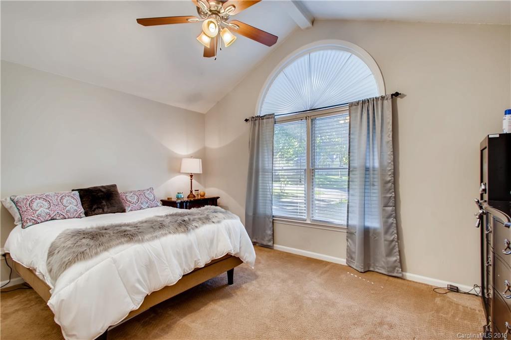 503 Southland Road Huntersville, NC 28078 - Photo 4 of 26 a bedroom with a bed and a chandelier