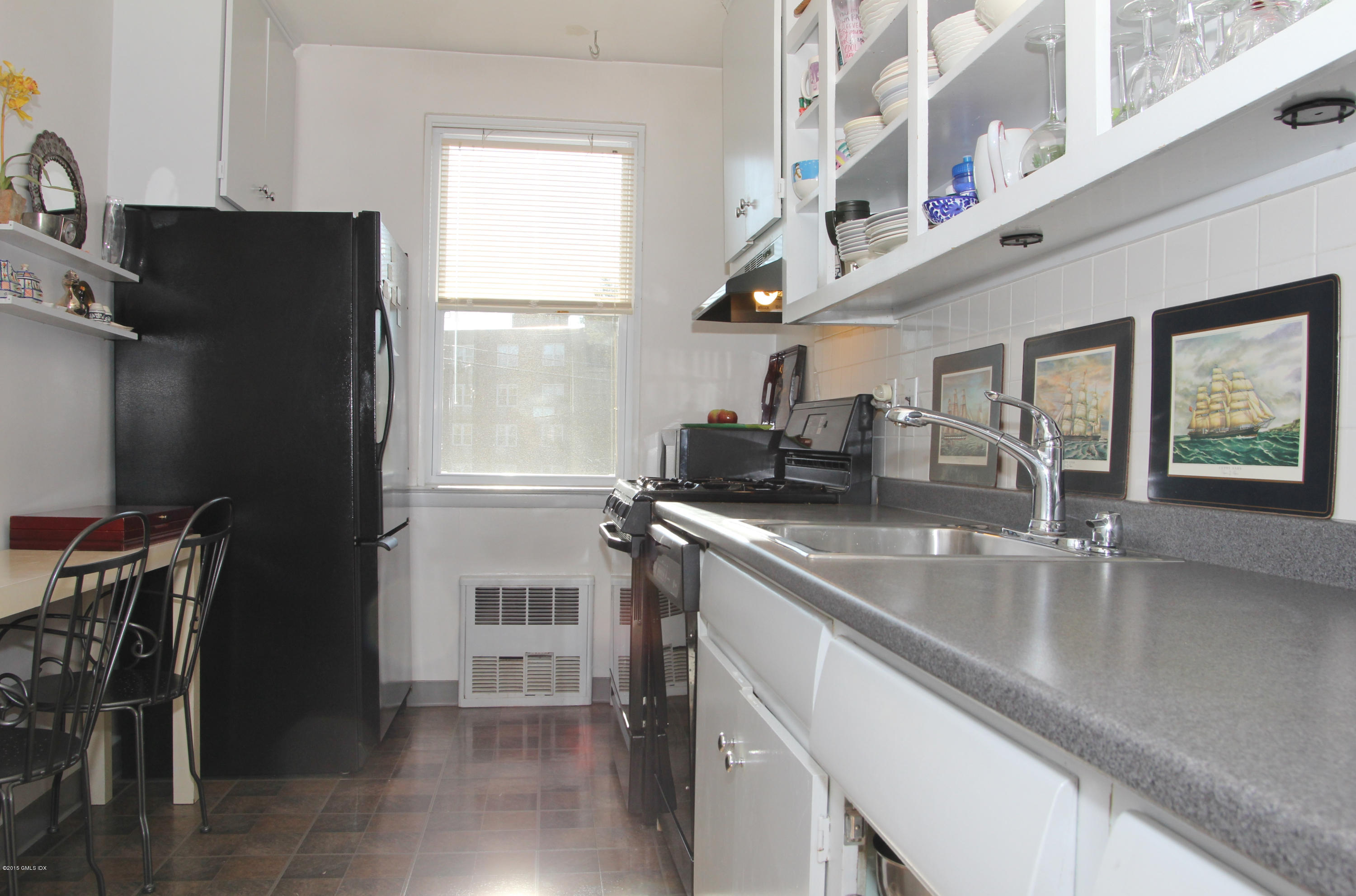 5 Putnam Hill, Unit 1F Greenwich, CT 06830 - Photo 11 of 18 a kitchen with stainless steel appliances granite countertop a refrigerator a sink a stove and island