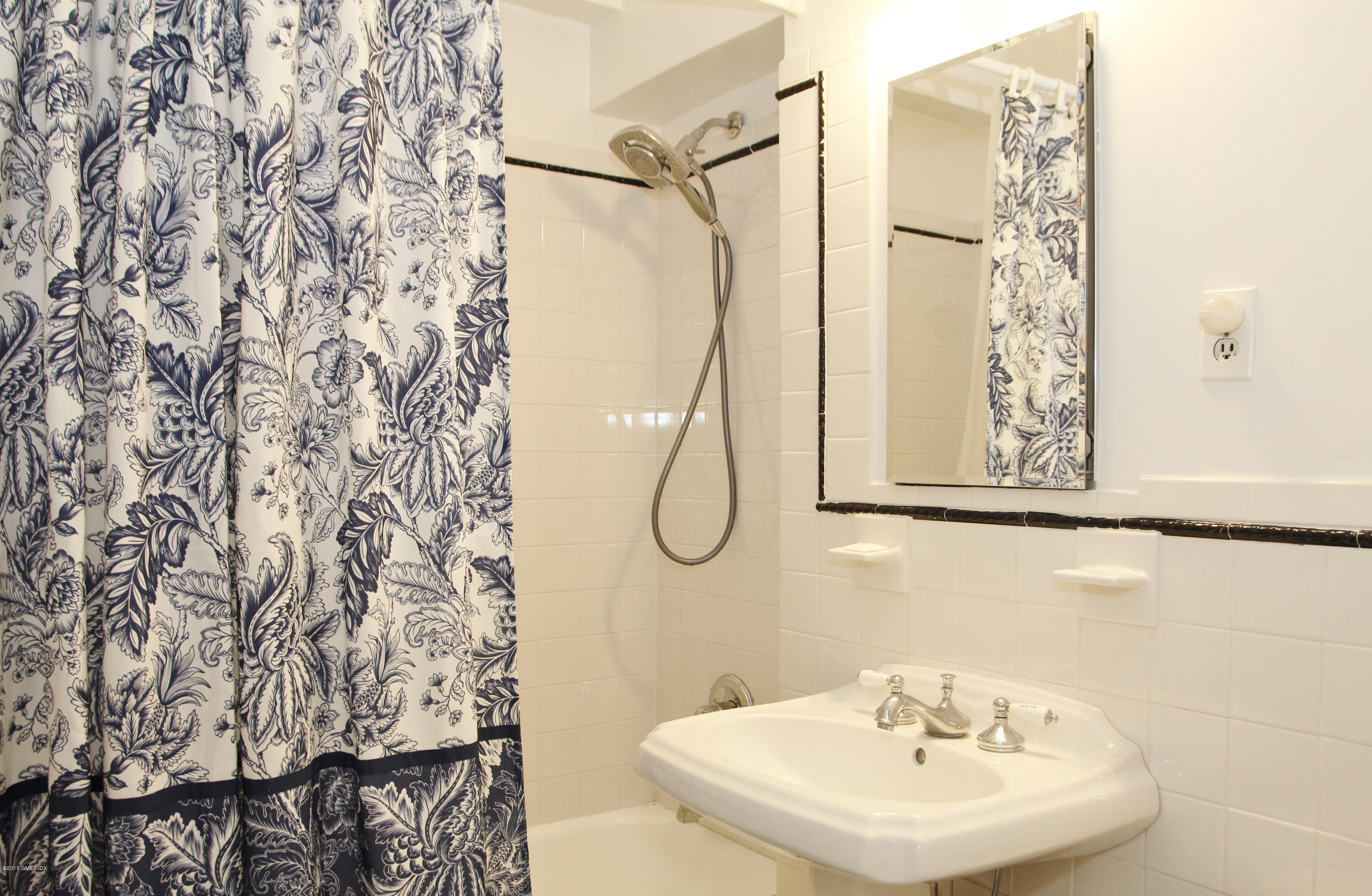 5 Putnam Hill, Unit 1F Greenwich, CT 06830 - Photo 13 of 18 a bathroom with a sink and a mirror