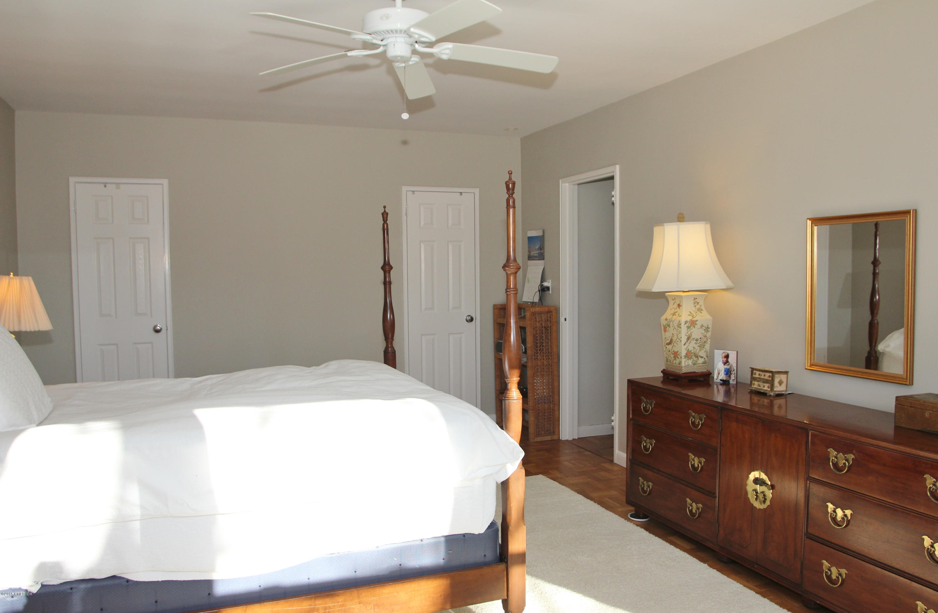 5 Putnam Hill, Unit 1F Greenwich, CT 06830 - Photo 14 of 18 a spacious bedroom with a bed and a dresser