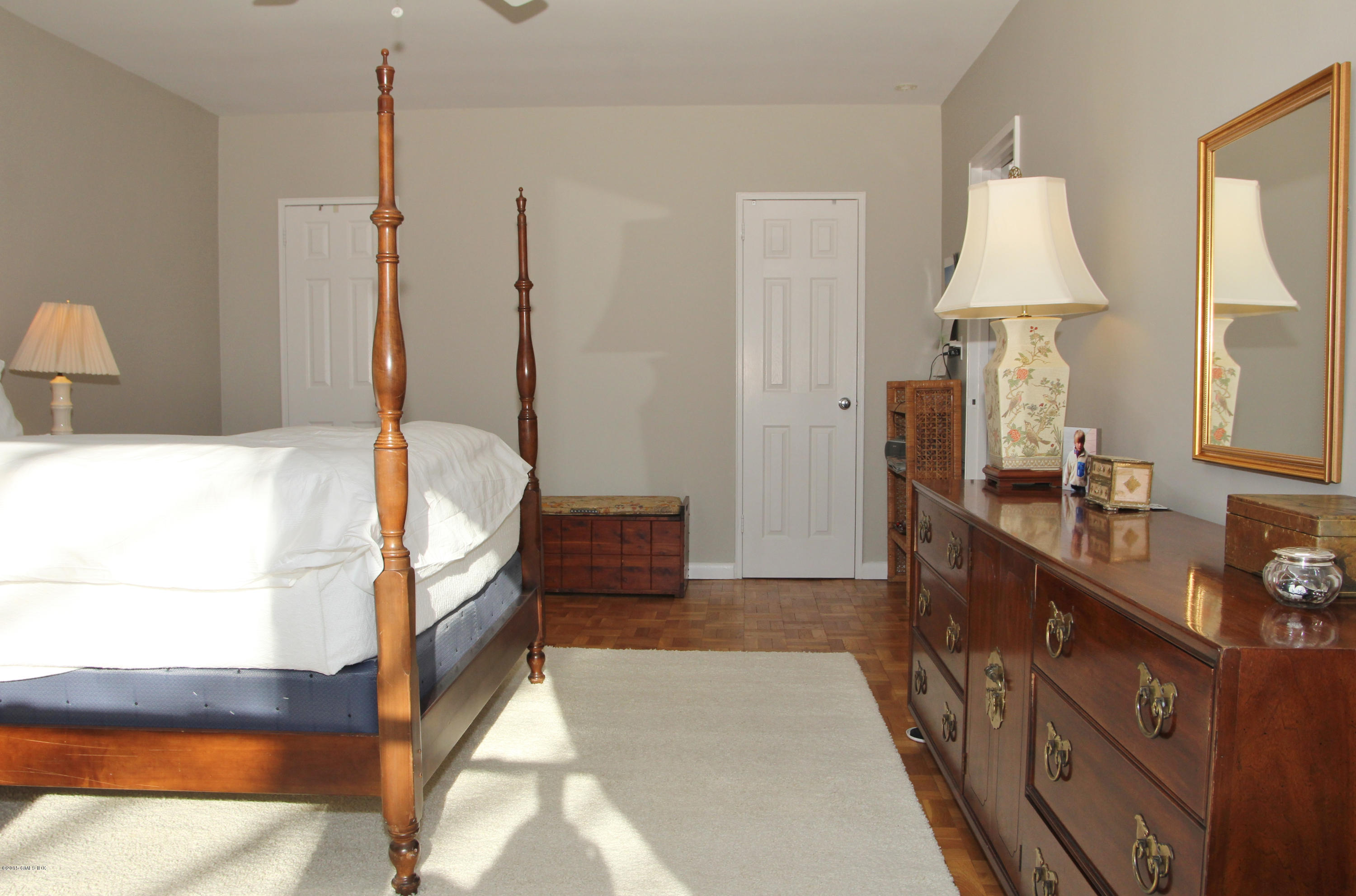 5 Putnam Hill, Unit 1F Greenwich, CT 06830 - Photo 15 of 18 a bathroom with a double vanity sink a mirror and a shower