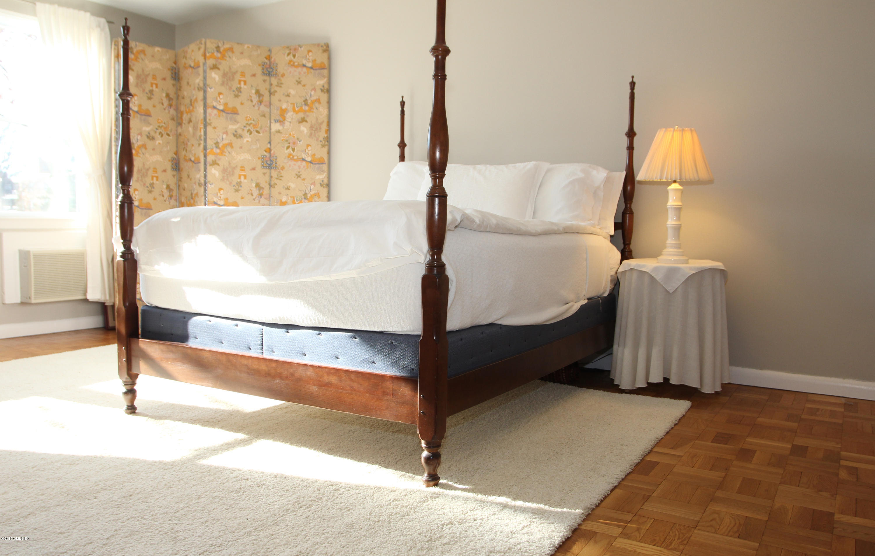 5 Putnam Hill, Unit 1F Greenwich, CT 06830 - Photo 17 of 18 a bed sitting in a bedroom next to a window