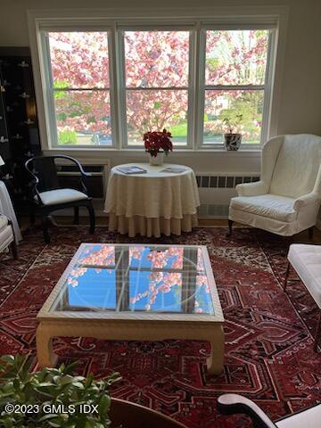 5 Putnam Hill, Unit 1F Greenwich, CT 06830 - Photo 5 of 18 a living room with furniture flat screen tv and large windows