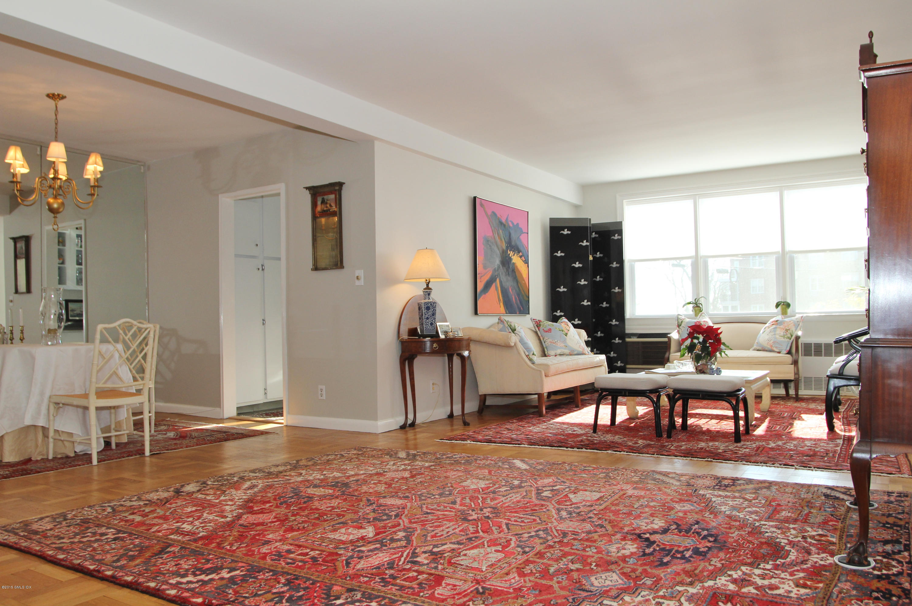5 Putnam Hill, Unit 1F Greenwich, CT 06830 - Photo 7 of 18 a living room with furniture a rug and a floor to ceiling window