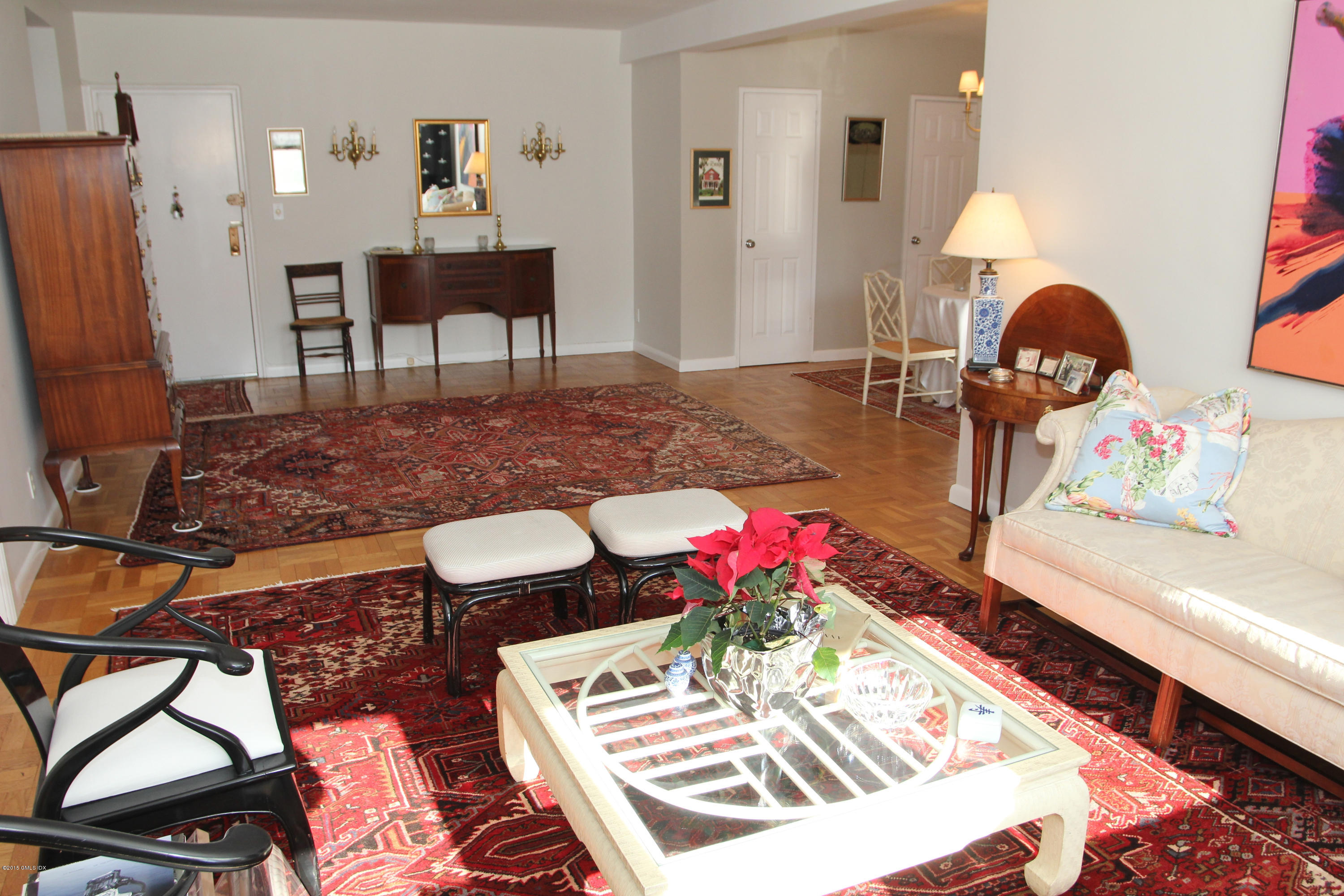 5 Putnam Hill, Unit 1F Greenwich, CT 06830 - Photo 10 of 18 a living room with furniture and a chandelier