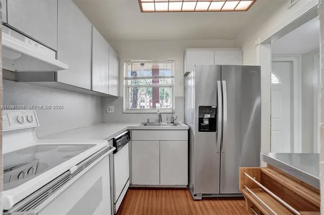 a kitchen with stainless steel appliances a refrigerator and a sink