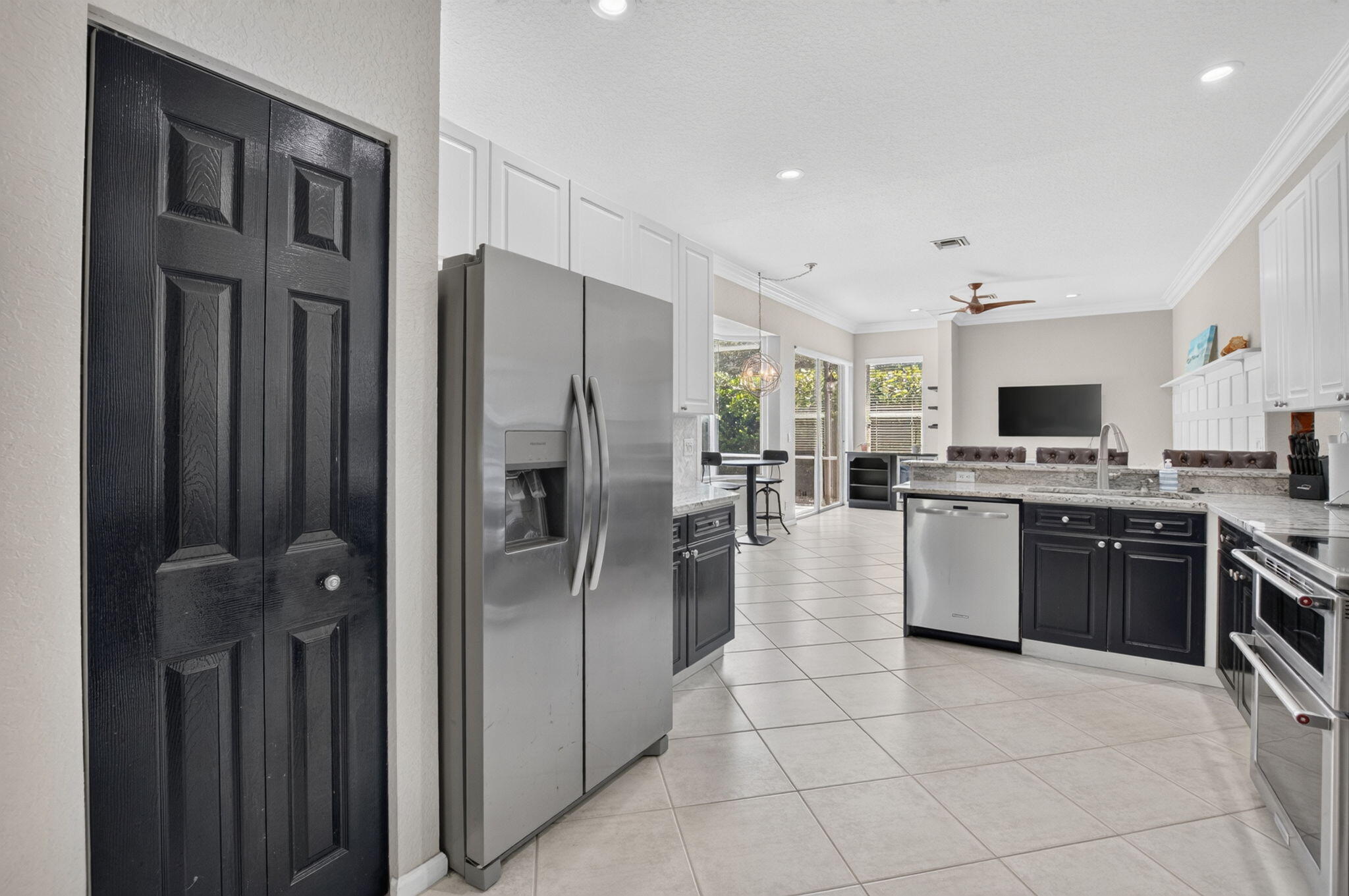 1365 East Barwick Ranch Circle Delray Beach, FL 33445 - Photo 36 of 77 a kitchen with stainless steel appliances granite countertop a refrigerator oven a stove top oven and a sink