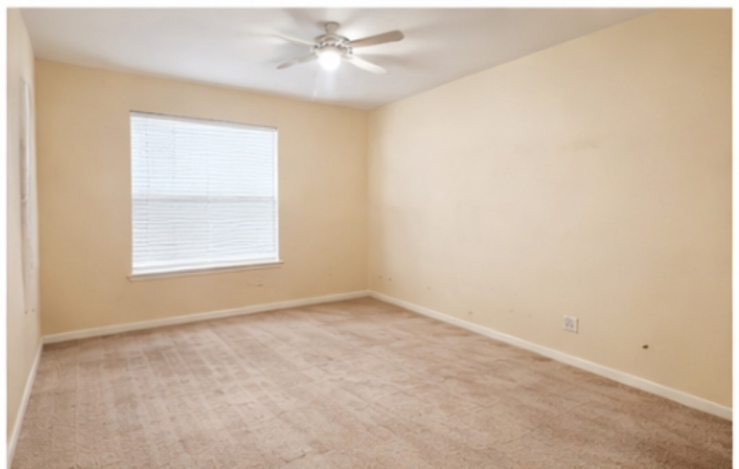 21530 Falvel Lake Drive Spring, TX 77388 - Photo 9 of 11 an empty room with a window and a ceiling fan
