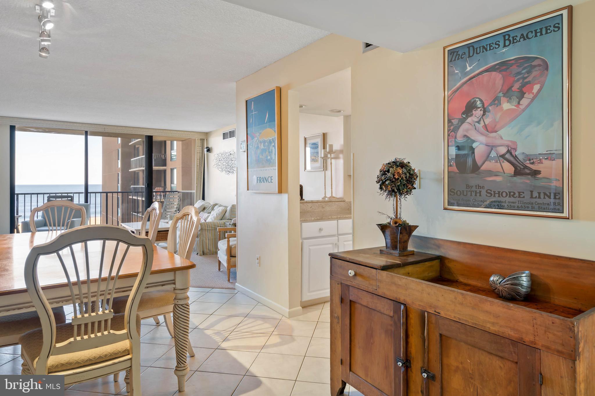 a view of a dining room with furniture a rug and wooden floor