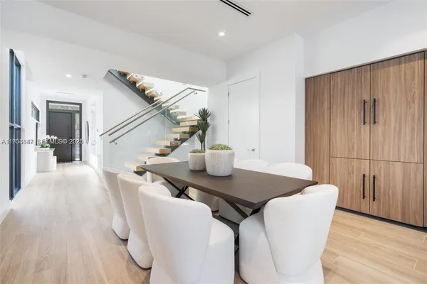 a view of a dining room with furniture and wooden floor
