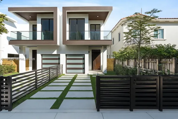a front view of a house with a garden