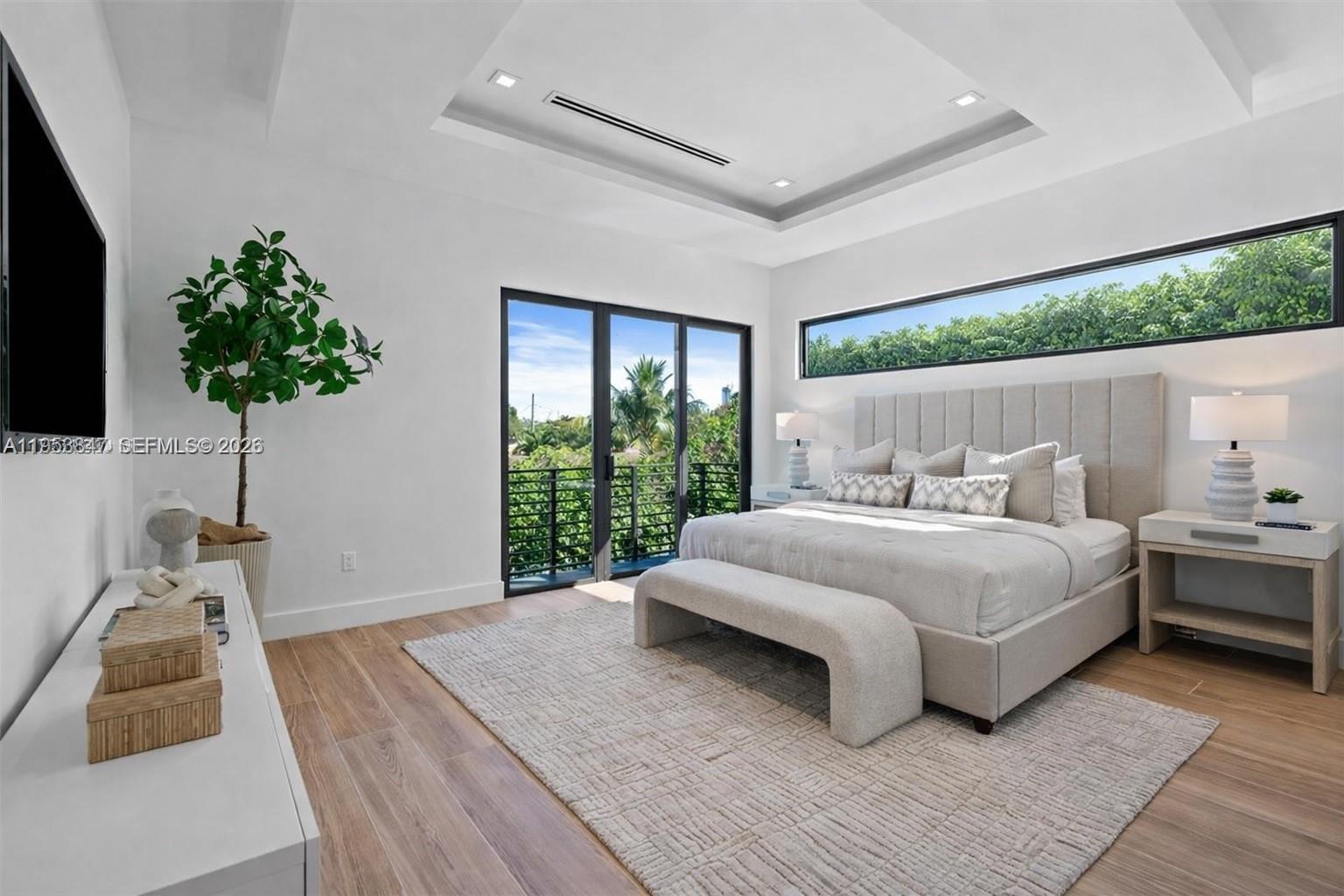 1245 Southwest 13th Avenue, Unit 1245 Miami, FL 33135 - Photo 9 of 19 a bed sitting in a spacious bedroom next to a window