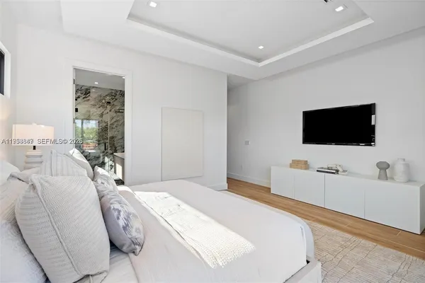 a bedroom with a bed and a flat screen tv
