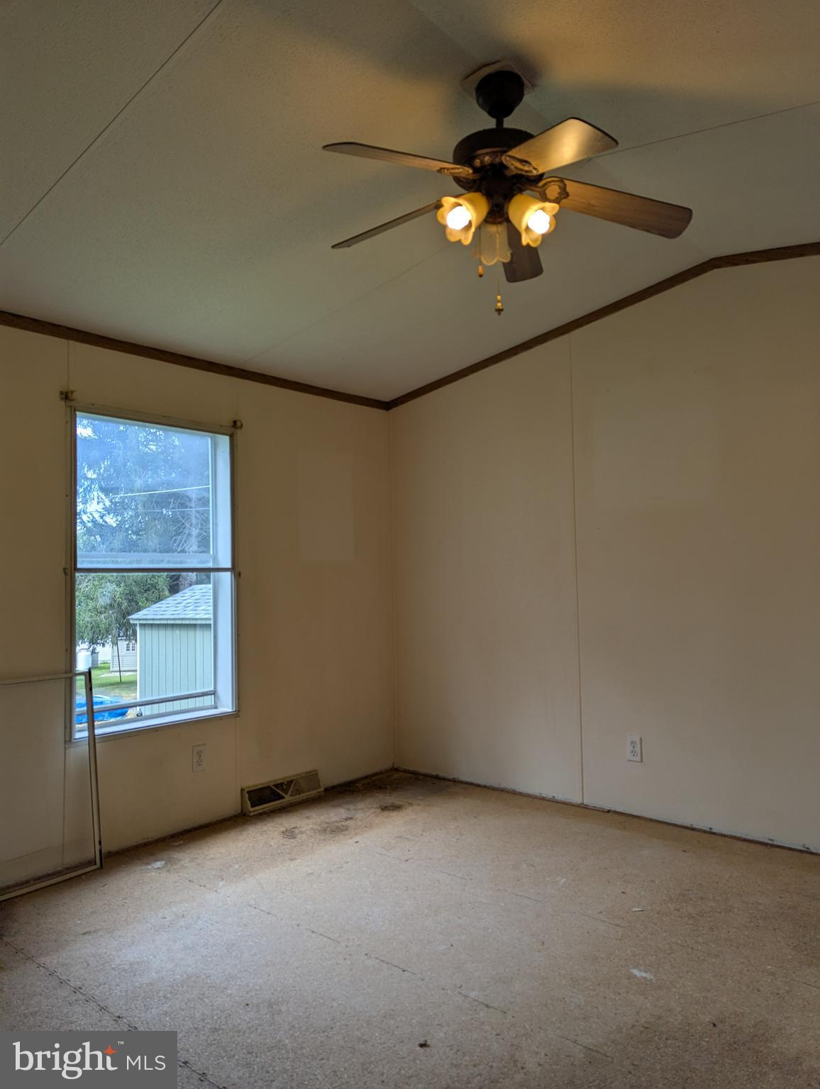2525 Baltimore Boulevard Finksburg, MD 21048 - Photo 17 of 25 an empty room with a chandelier fan and a large window