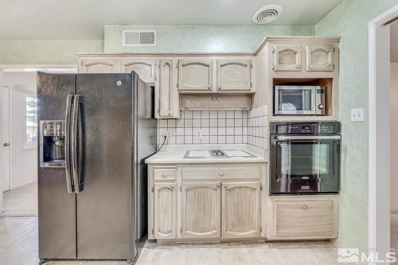 1935 Brisbane Avenue Reno, NV 89503 - Photo 11 of 38 a kitchen with stainless steel appliances granite countertop a refrigerator and a stove