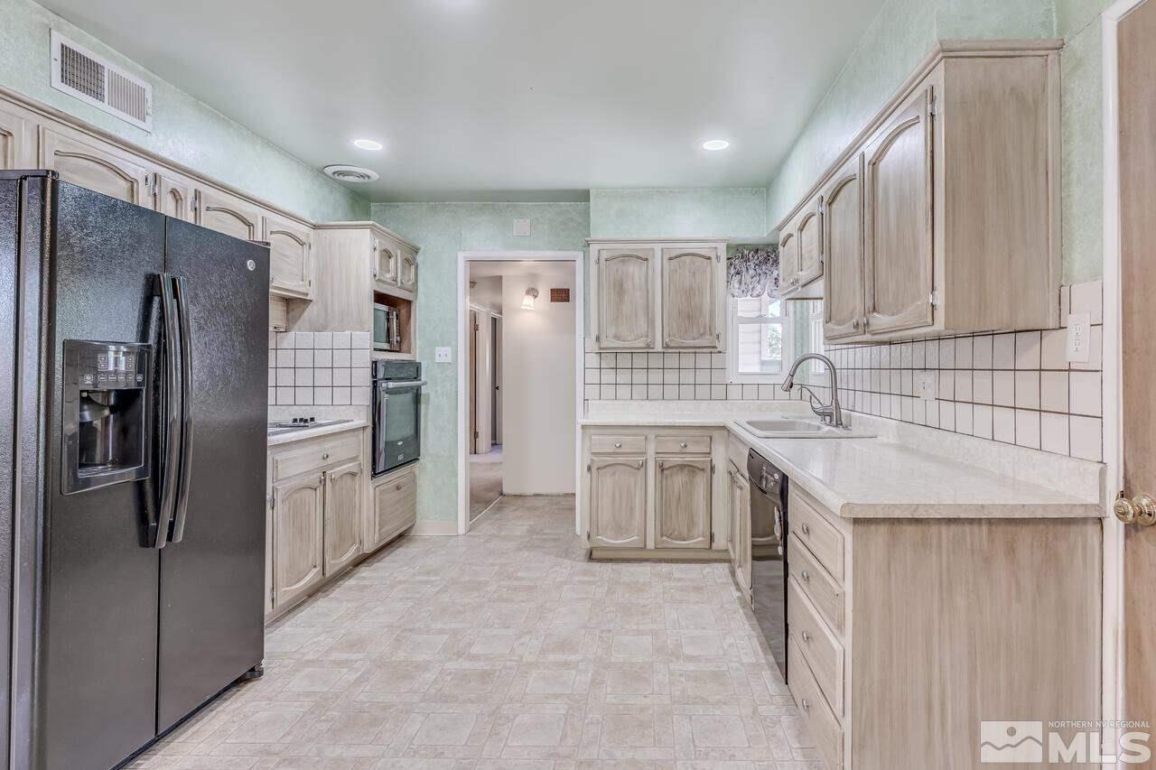 1935 Brisbane Avenue Reno, NV 89503 - Photo 12 of 38 a kitchen with stainless steel appliances granite countertop a refrigerator and a sink