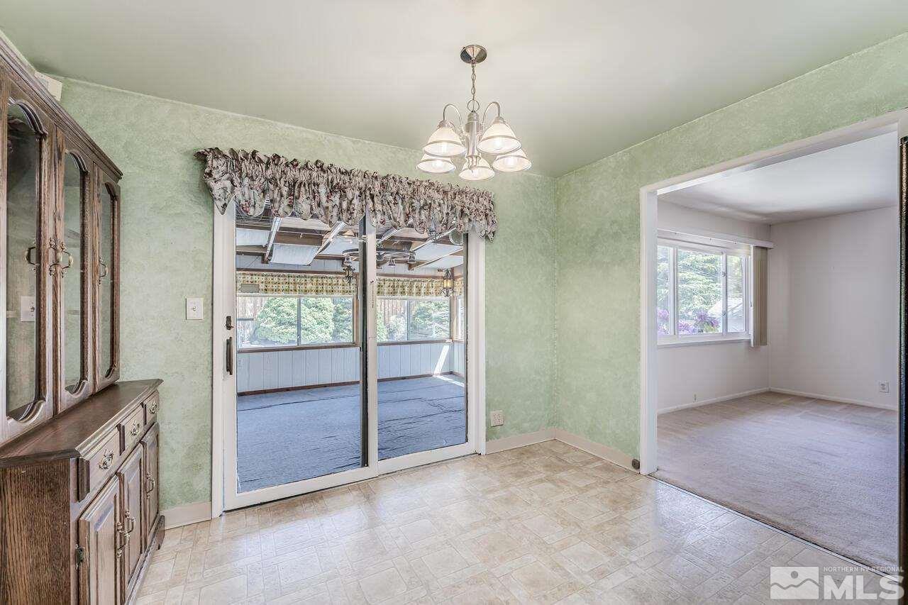 1935 Brisbane Avenue Reno, NV 89503 - Photo 13 of 38 a view of a livingroom with a chandelier fan and windows