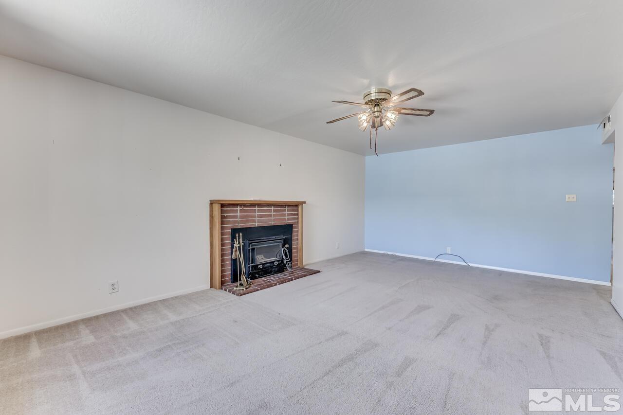 1935 Brisbane Avenue Reno, NV 89503 - Photo 15 of 38 a view of a livingroom with a fireplace and a chandelier fan