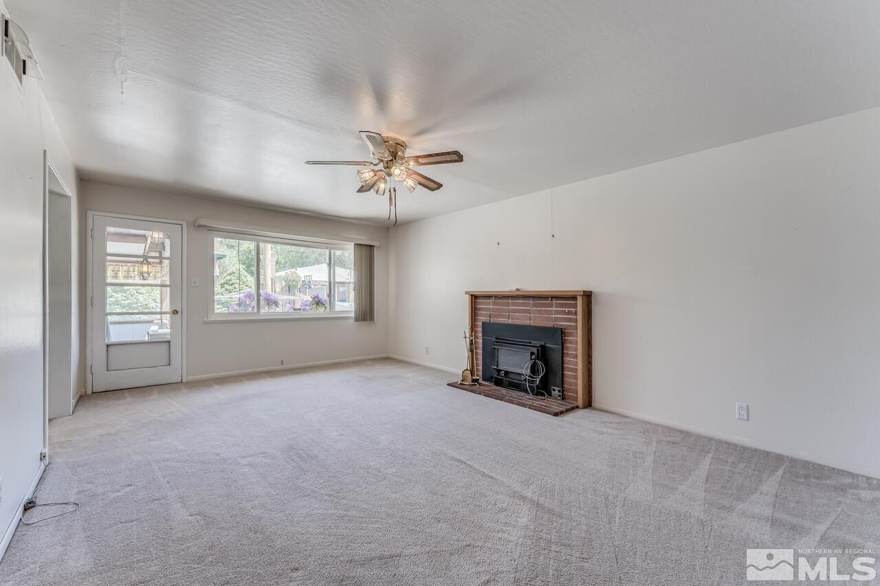 1935 Brisbane Avenue Reno, NV 89503 - Photo 18 of 38 an empty room with windows and fireplace