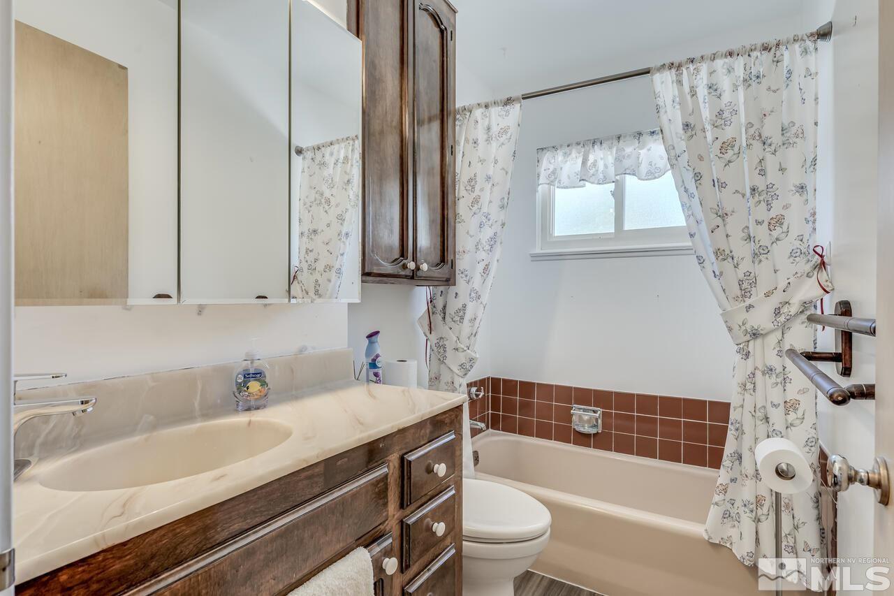 1935 Brisbane Avenue Reno, NV 89503 - Photo 19 of 38 a bathroom with a bathtub a sink and a window