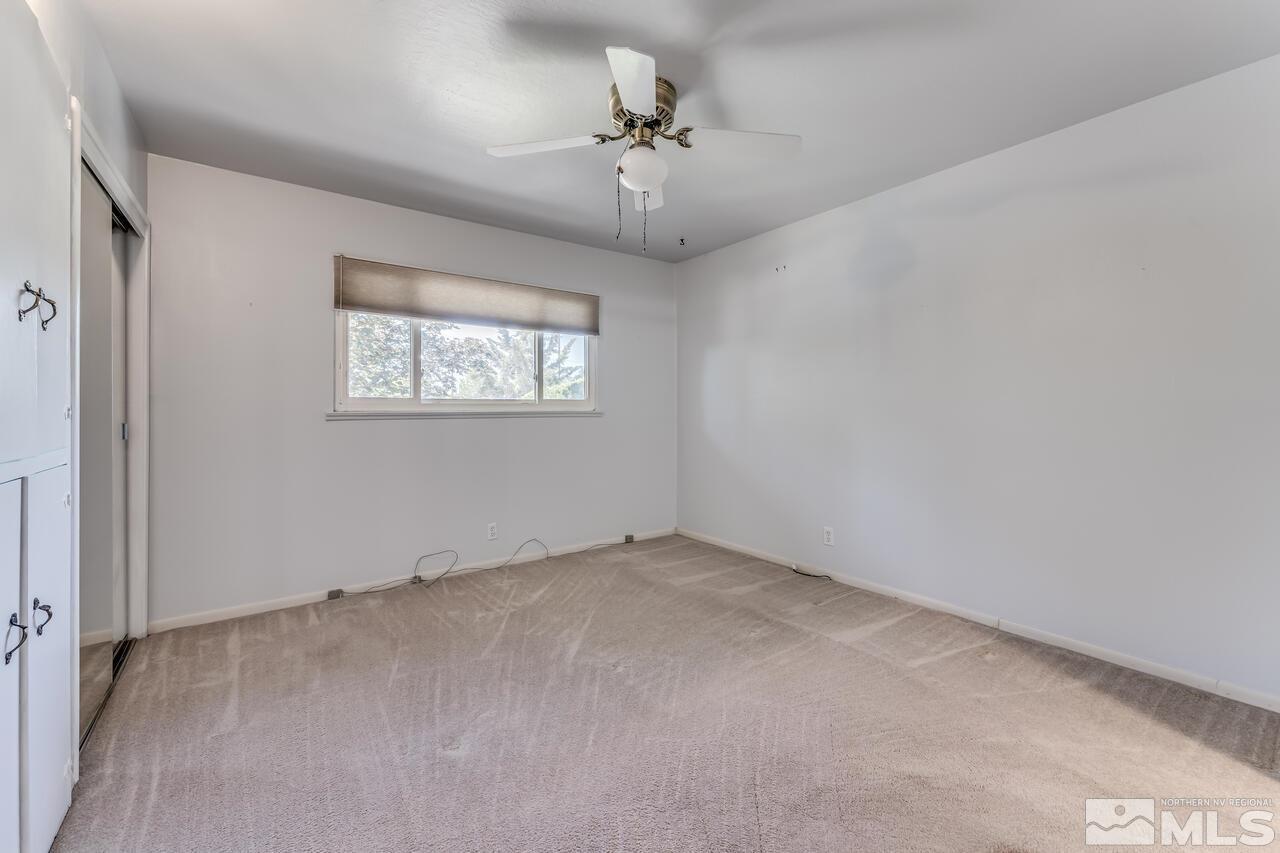 1935 Brisbane Avenue Reno, NV 89503 - Photo 22 of 38 an empty room with a chandelier fan and windows