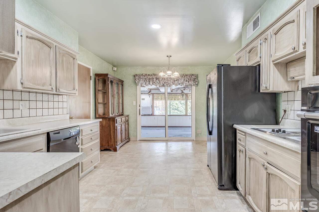 1935 Brisbane Avenue Reno, NV 89503 - Photo 9 of 38 a kitchen that has a lot of cabinets in it and stainless steel appliances