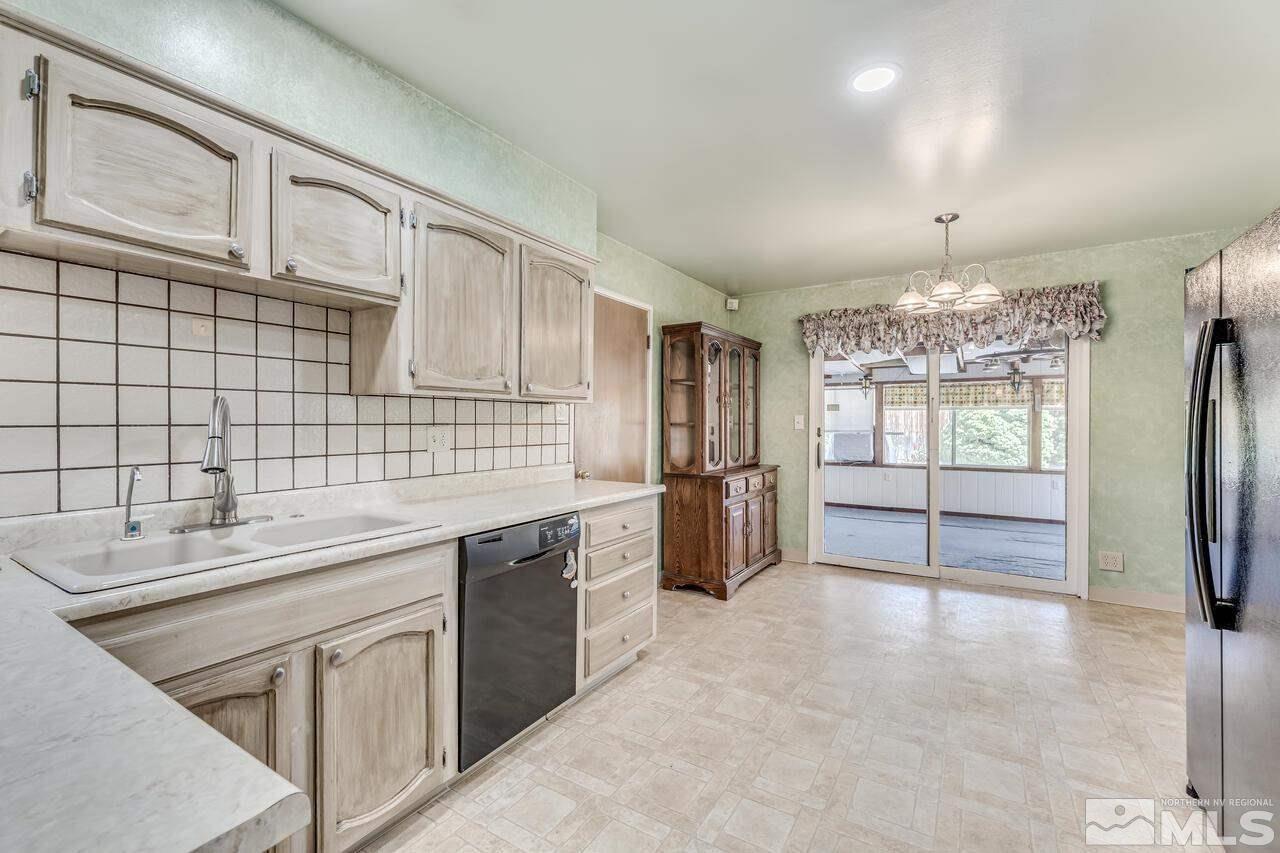 1935 Brisbane Avenue Reno, NV 89503 - Photo 10 of 38 a kitchen with stainless steel appliances granite countertop a sink stove and refrigerator